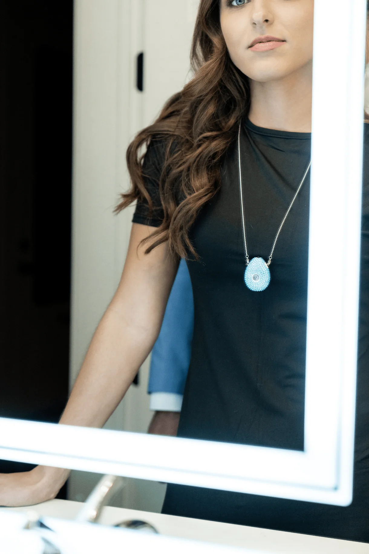 Portable Holistix wellness pendant shown in a mirror setting